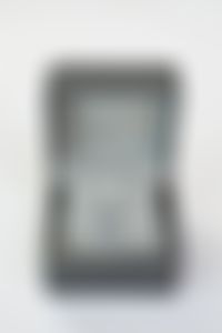 The 18k white gold pendant features a natural blue sapphire with a diamond halo.